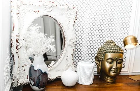 A golden Buddha head on a table. Stock Photos