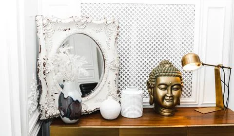 A golden Buddha head on a table. Stock Photos