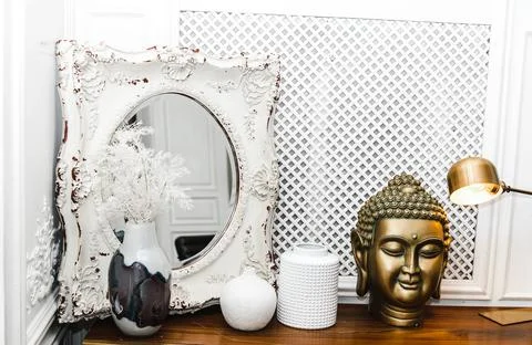 A golden Buddha head on a table. Stock Photos