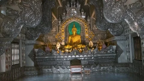Golden Buddha statue inside elaborately decorated Silver Temple interior with Stock Footage 315857222