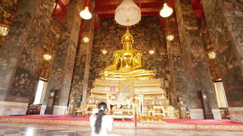 Golden Buddha Statue Inside Thai Temple Hall with Worshipper at Wat Suthat Stock Footage 322223611