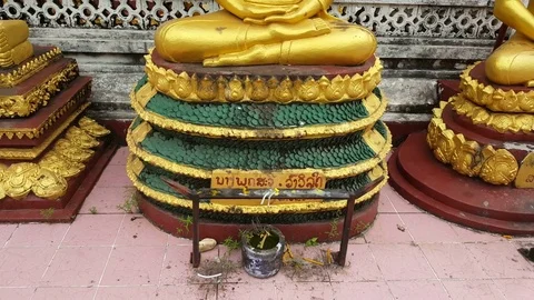 Golden Buddha statues base, incense, sitting pose, half Lotus, Vientiane, Laos Video stock 75554658