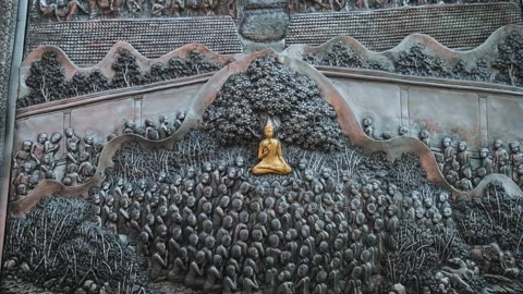 Golden Buddha teaching large group of disciples in detailed silver relief Stock Footage 315857299