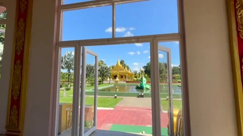 Golden Buddhist Temple Viewed Through Open Glass Doors Stock-Footage 329175001