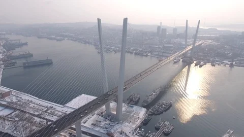 Golden cable-state Bridge bay Vladivostok Russia Snow winter car traffic Aerial  Stock Footage 86502647