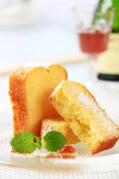 Golden cake slice with mint garnish on plate Stock Photos