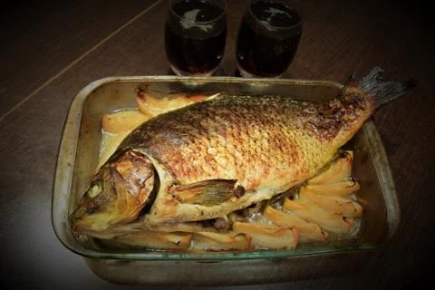 Golden carp baked with apples Stock Photos