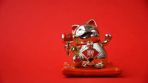 Golden cat Maneki-neko waves his paw Stock Footage 126928384