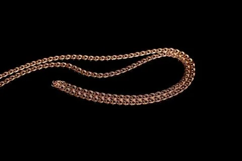 Golden chain weaving non, on a black background with reflection. Isolate, mac Stock Photos