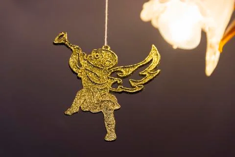 A Golden Christmas angel is hanging on the branch Stock Photos