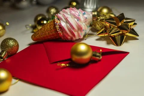 Golden Christmas Bauble on Red Envelope Holiday Card Stock Photos