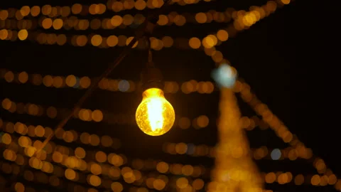 Golden christmas lights string glowing at night Video stock 332237588