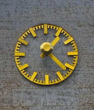 Golden Clock on Stone Wall Stock Photos