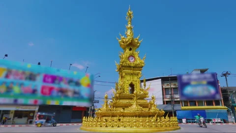 Golden Clock Tower in Chiang Rai Thailand with street traffic Stock Footage 342336488