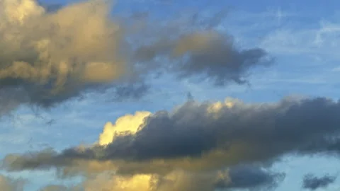 Golden Clouds in a Blue Sky at Sunset Stock Footage 276837113
