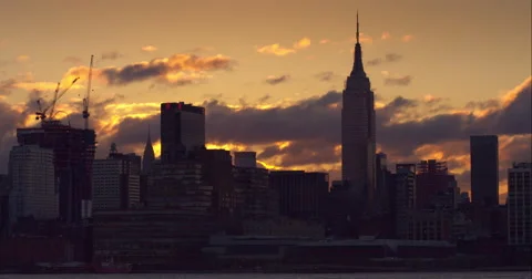 Golden clouds passing by the Empire State Building in the Manhattan skyline Stock Footage 51295893