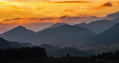 Golden clouds sky moving fast over summer mountains landscape at sunset time Stock Footage 265797879