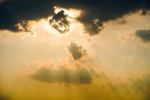 Golden clouds with sun rays, sun blocked Stock Photos