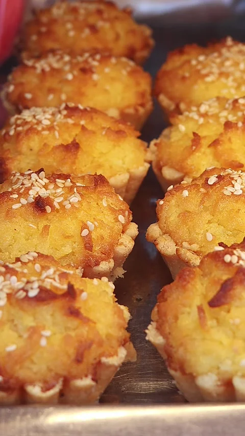 Golden Coconut Tartlets Displayed in Bakery Showcase Stock Footage 337736048
