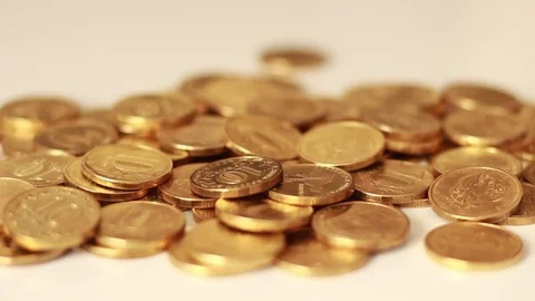 Golden coins falling on a table Stock Footage 73506942