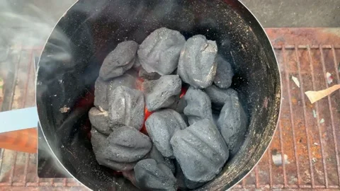 Golden colored coal starting ready for a BBQ Video stock 135765495