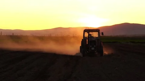 Golden colored dust from a tractor working in the field Stock Footage 142667439