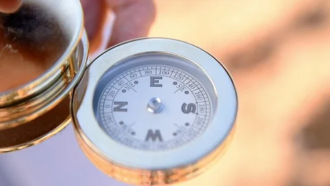 Golden compass on hand Stock Footage 98424996