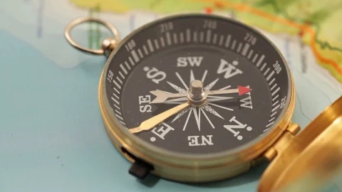 Golden compass lying on an abstract map Stock Footage 92409096