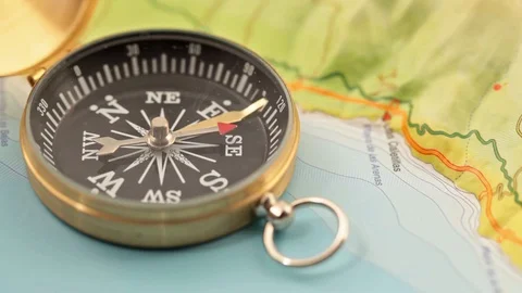 Golden compass lying on an abstract map Stock Footage 92409106