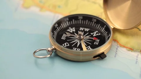 Golden compass lying on an abstract map Stock Footage 92409129