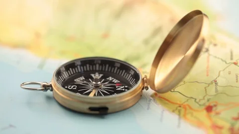Golden compass lying on an abstract map Stock Footage 92409175