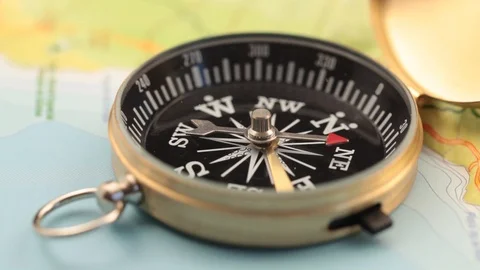 Golden compass lying on an abstract map Stock Footage 92409212