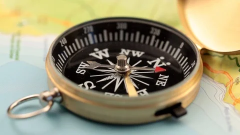 Golden compass lying on an abstract map Stock Footage 92409245