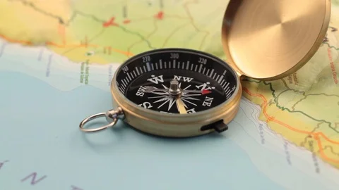 Golden compass lying on an abstract map Stock Footage 92409260