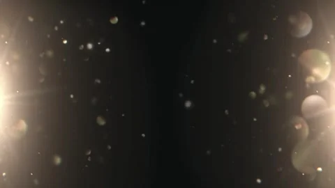 Golden confetti particles falling against dark background Video stock 337523962