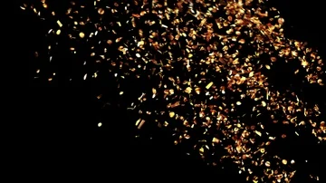 Golden Confetti Party Popper Explosions on a Green and Black Backgrounds Stock Footage
