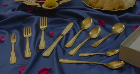 Golden coplor spoon and fork cutlery set on the table Stock Footage 260543024
