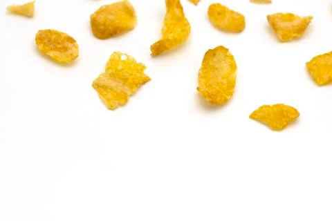 Golden cornflakes splash on white background with copy space text Foto stock