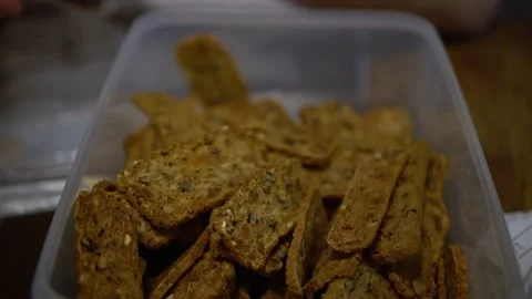 Golden crackers made at home ginger snaps crumbs Tupperware professional Stock Footage 166019294