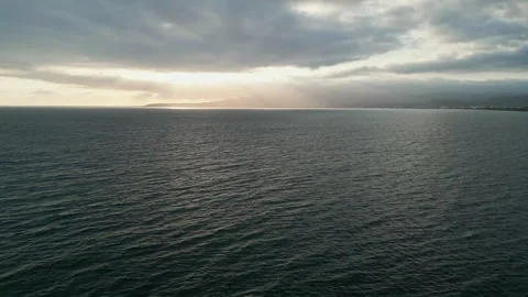 Golden crepuscular rays breaking through clouds over the Pacific Stock-Footage 342089771