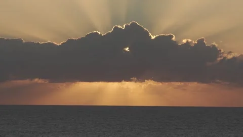 Golden Crepuscular Rays Through Dark Cloud Bank Over The Ocean - Dramatic Stock Footage 336244644