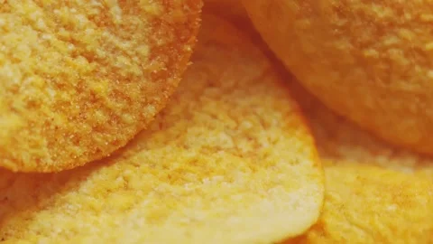 Golden Crispy Potato Chips Spinning in Bowl Overhead Macro Shot Stock Footage 314200092