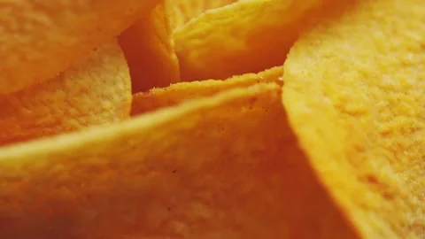 Golden Crispy Potato Chips Spinning in Bowl Overhead Macro Shot Stock Footage 314200097