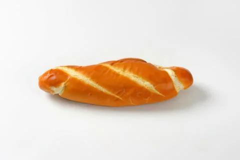 Golden croissant roll on plain surface Stock Photos