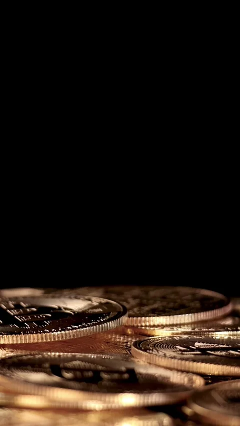 Golden Cryptocurrency Coin Dropping Onto Stack in Dark Studio Stock Footage 316576750
