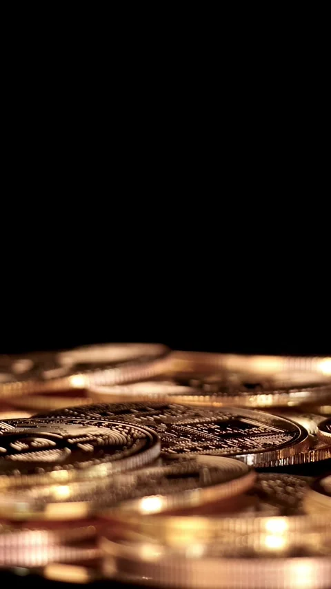 Golden Cryptocurrency Coin Drops Onto Stack in Dramatic Stock Footage 316657379