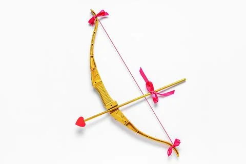 Golden cupid's bow on light background. Valentine's Day celebration Stock Photos