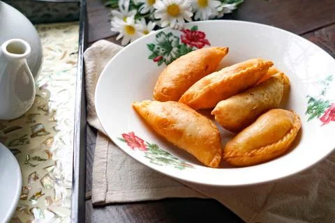 Golden Curry Puffs With Rustic Tea Set Stock Photos