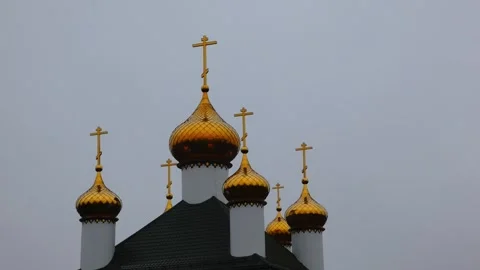 Golden domes shine under gray sky in a city with rich history and culture Stock Footage 332015490