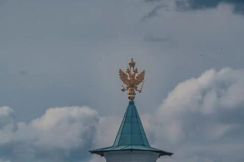 Golden double-headed eagle on a turquoise dome against the sky Stock Photos